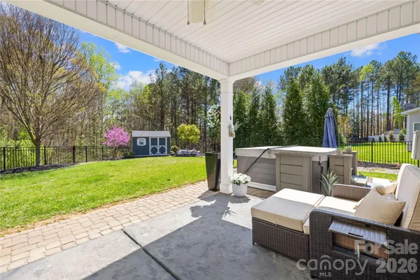 a view of backyard with seating area and green space