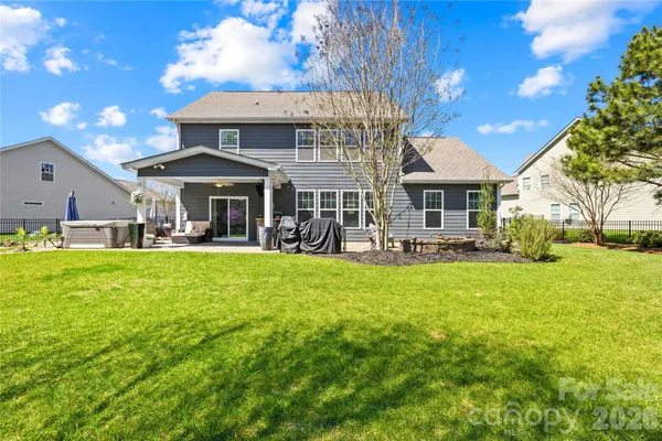 a front view of a house with swimming pool garden and patio