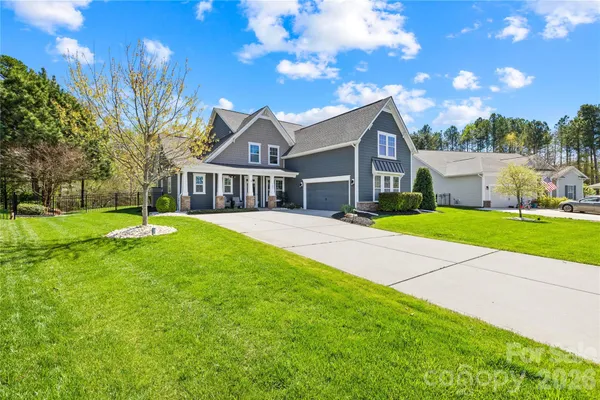 a view of house with yard and green space