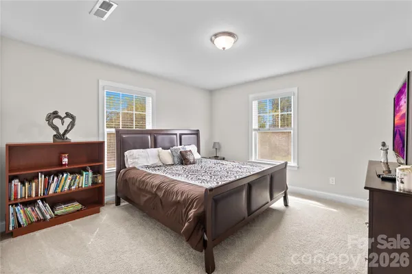 a bedroom with a bed a bookshelf and a bookshelf