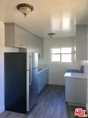 a kitchen with refrigerator and window
