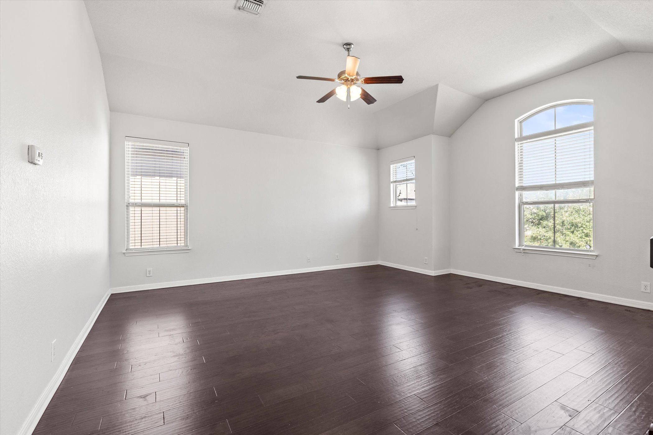 7337 Menchaca Road, Unit #22 Austin, TX 78745 - Photo 15 of 25 Spacious, upstairs media room featuring plenty of natural light, lofted ceiling, wood flooring, and a ceiling fan
