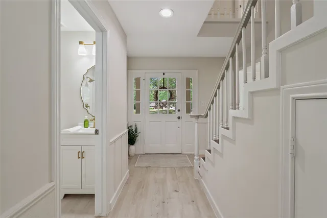 a view of an entryway with wooden floor