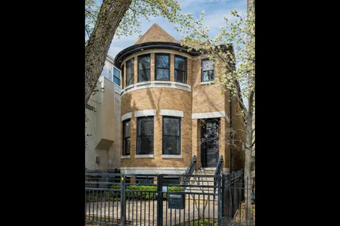 a view of a brick house with large windows