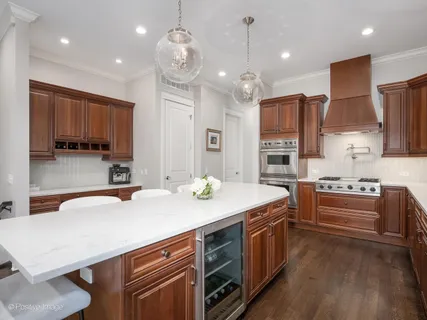 a kitchen with stainless steel appliances a sink stove and refrigerator