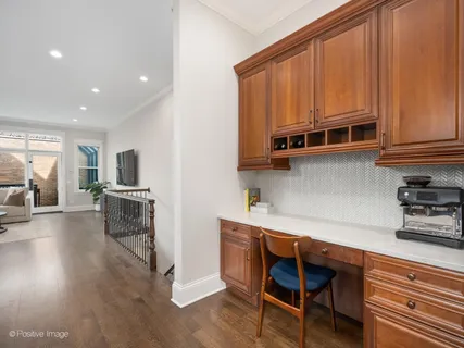 a kitchen with stainless steel appliances wooden floors and wooden cabinets