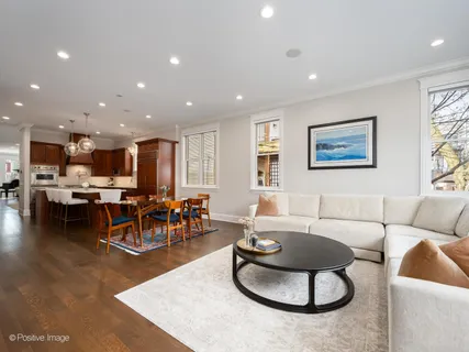 a living room with furniture kitchen and a table