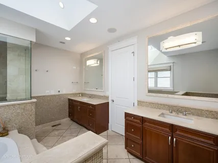 a spacious bathroom with a sink mirror and a bathtub