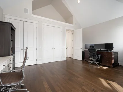 a view of a workspace with furniture and a bathroom