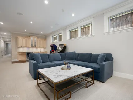 a living room with furniture and a kitchen view