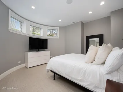 a bedroom with a large bed and a tv