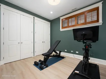 a room with gym equipment and a flat screen tv