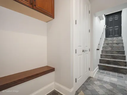 a view of a hallway with wooden floor and entryway