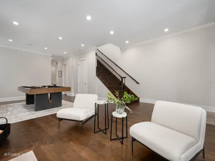 a living room with furniture and stairs