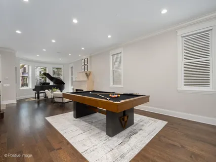 a living room with furniture a table and wooden floor