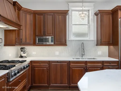 a kitchen with wooden cabinets and a stove top oven
