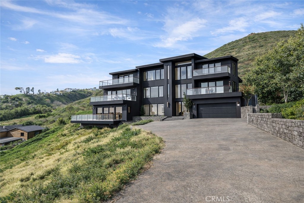 29675 Cuthbert Road Malibu, CA 90265 - Photo 7 of 7 a view of a house with a yard and roof