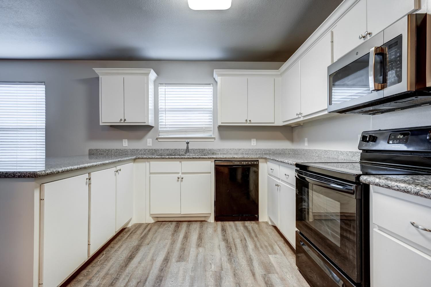 3450 Itasca Street Lubbock, TX 79415 - Photo 11 of 24 a kitchen with granite countertop cabinets stainless steel appliances a sink and window