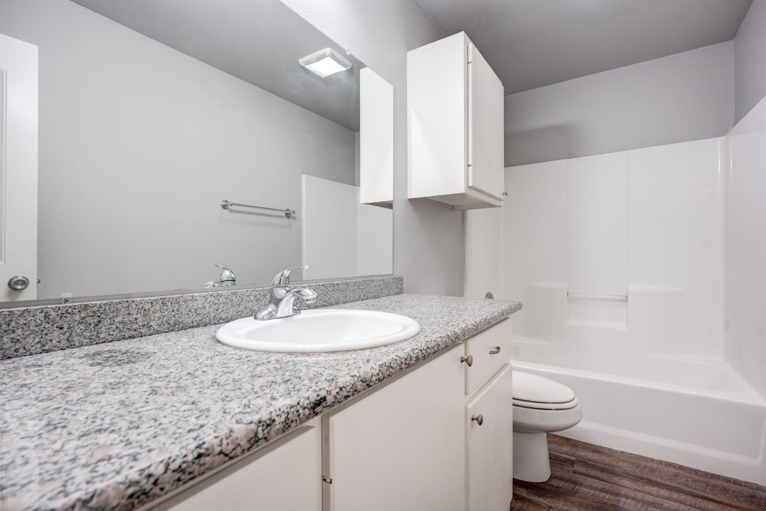 3450 Itasca Street Lubbock, TX 79415 - Photo 20 of 24 a bathroom with a granite countertop sink and a mirror