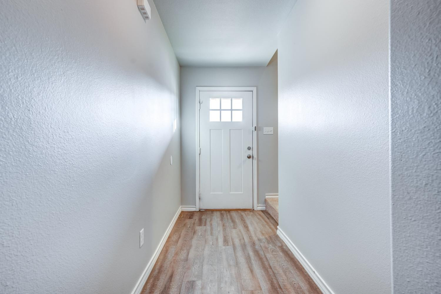 3450 Itasca Street Lubbock, TX 79415 - Photo 22 of 24 a view of a hallway with wooden floor