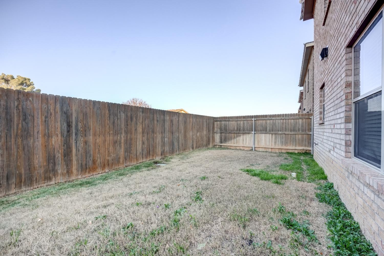 3450 Itasca Street Lubbock, TX 79415 - Photo 24 of 24 a view of backyard with wooden fence