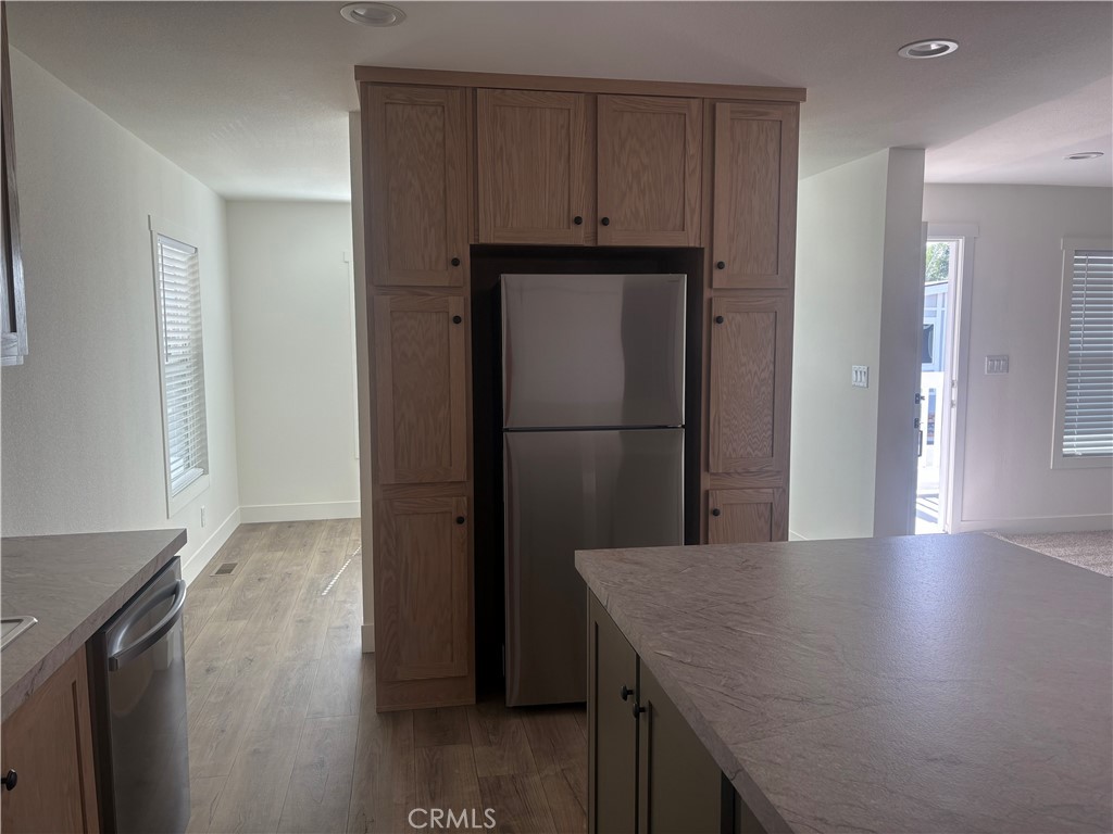 4361 Mission Boulevard, Unit 151 Montclair, CA 91763 - Photo 11 of 39 a kitchen with a refrigerator and countertop