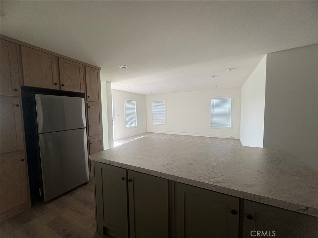 4361 Mission Boulevard, Unit 151 Montclair, CA 91763 - Photo 12 of 39 a view of kitchen with a refrigerator cabinets and wooden floor