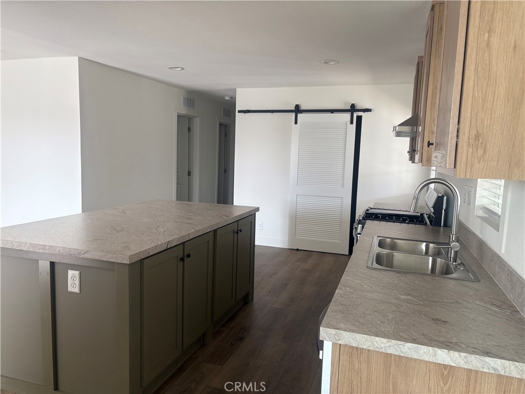 4361 Mission Boulevard, Unit 151 Montclair, CA 91763 - Photo 18 of 39 a kitchen with kitchen island a counter top space and a sink