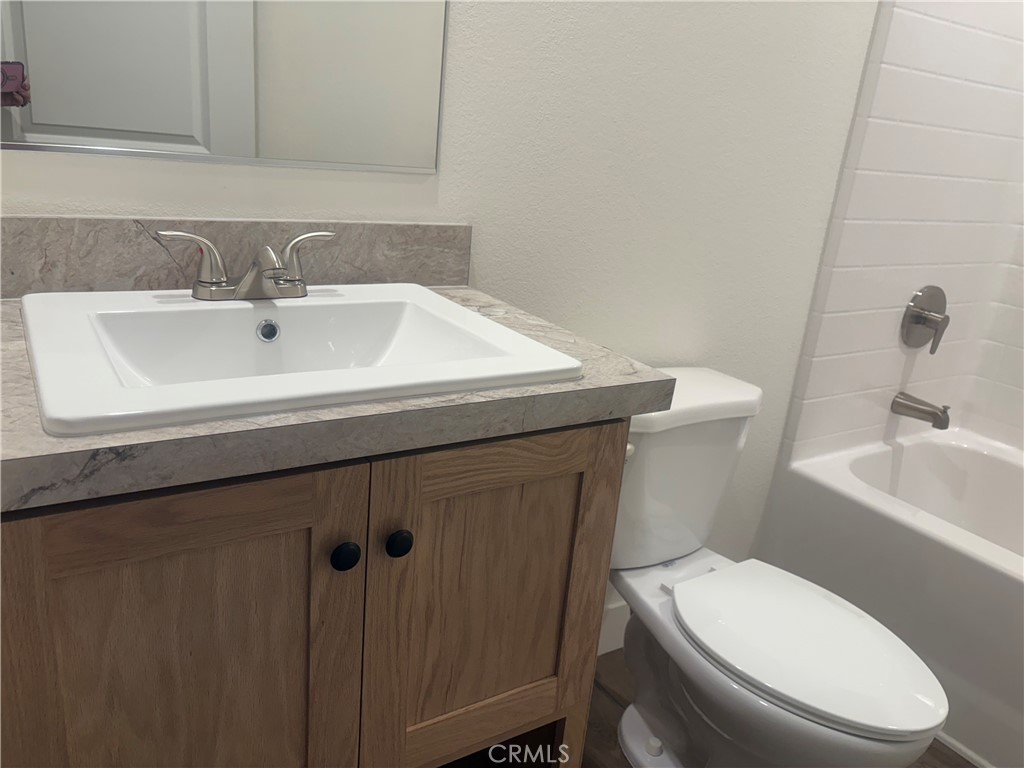 4361 Mission Boulevard, Unit 151 Montclair, CA 91763 - Photo 24 of 39 a bathroom with a sink a toilet and mirror