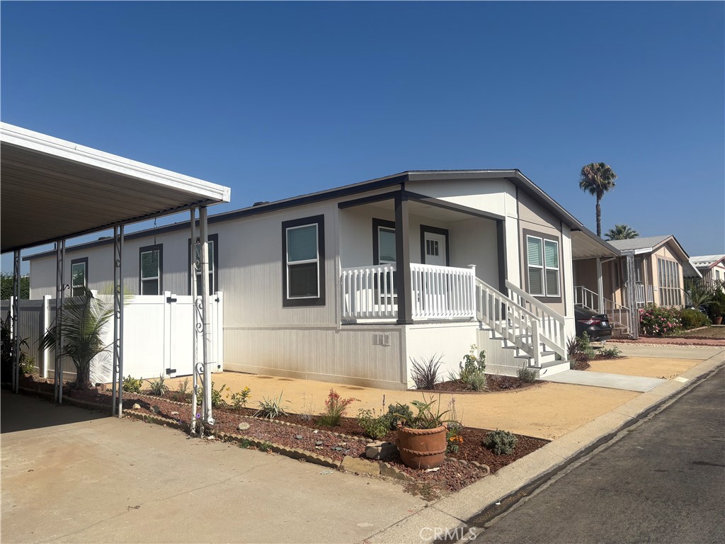 4361 Mission Boulevard, Unit 151 Montclair, CA 91763 - Photo 5 of 39 a front view of a house with a yard