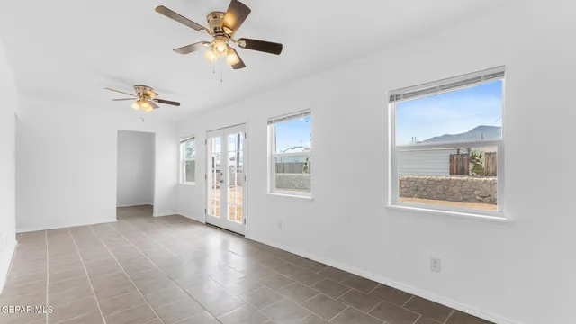 a view of a small space with wooden floor and a window