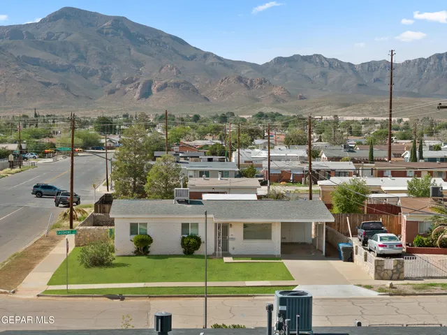 an aerial view of residential house and sandy dunes