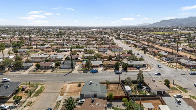 an aerial view of residential houses with city view