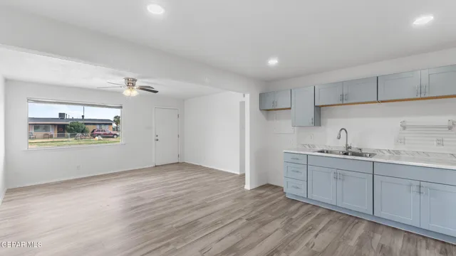 a view of a kitchen with wooden floor and window