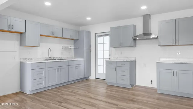 a kitchen with white cabinets and appliances