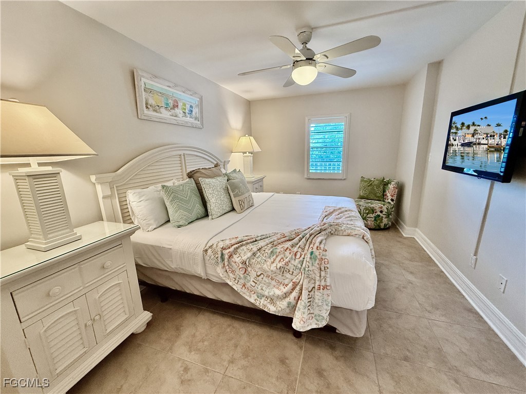 5232 Bayside Villas Captiva, FL 33924 - Photo 11 of 29 a bedroom with a bed and a chandelier