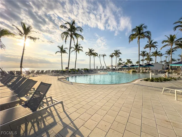 a swimming pool with outdoor seating and yard
