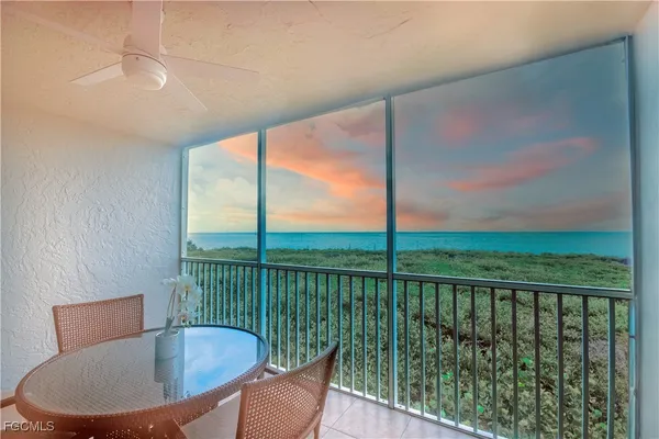 a view of a chair and tables in the balcony