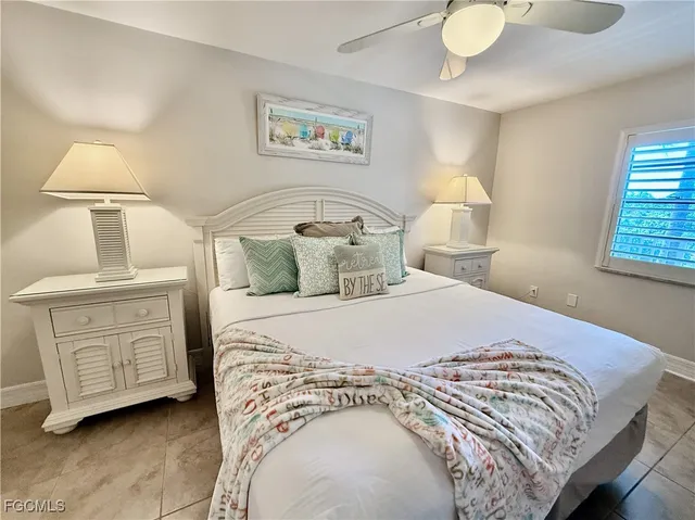 a bedroom with a bed and a night stand