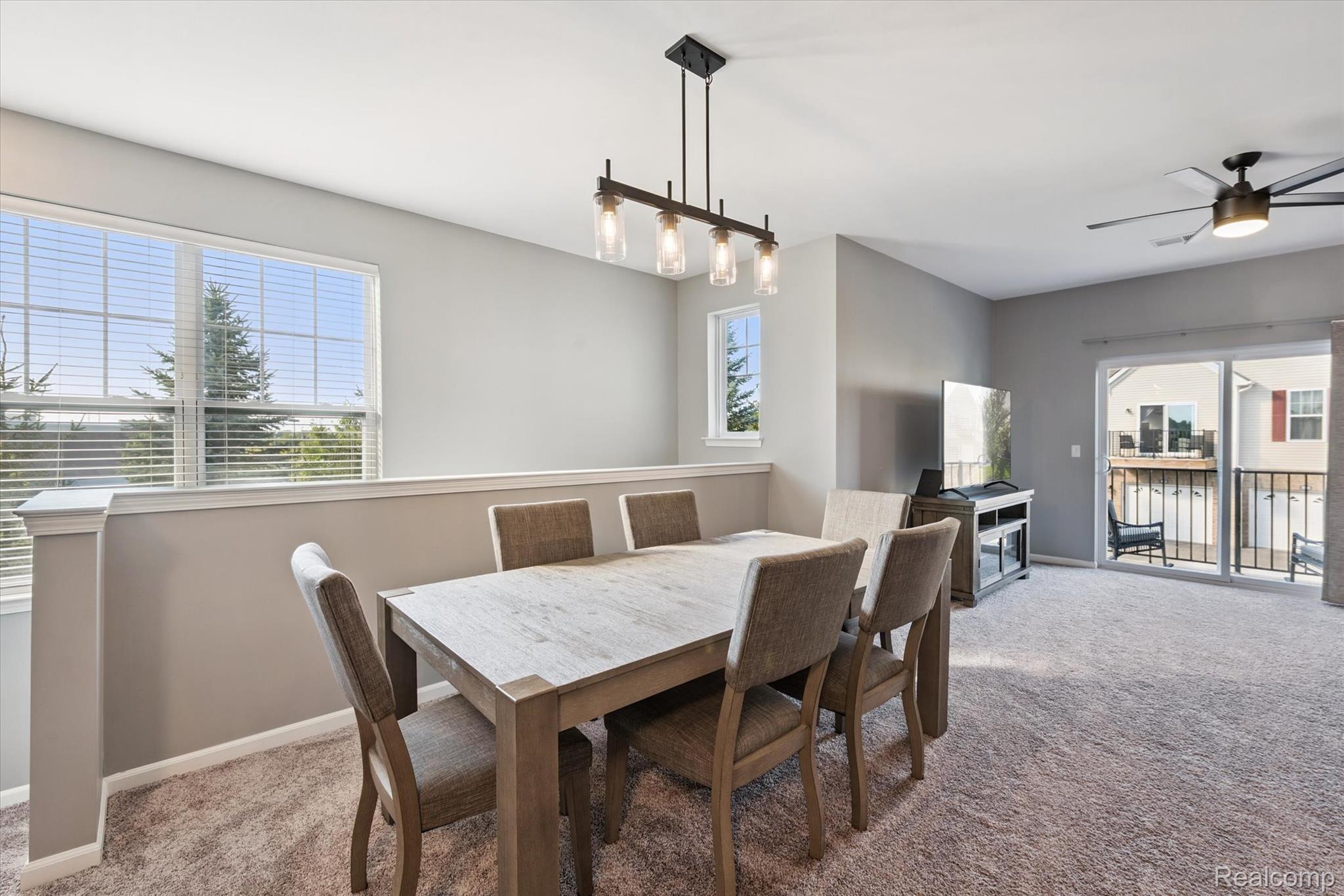 9930 Ridge Run Street Howell, MI 48855 - Photo 8 of 19 Dining area with modern chandelier.
