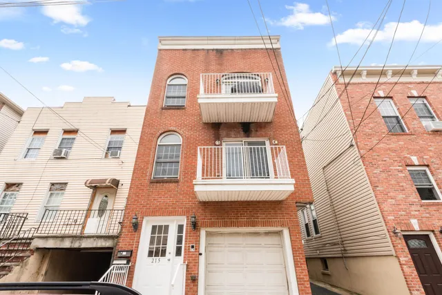 a view of a brick building with floor to ceiling windows