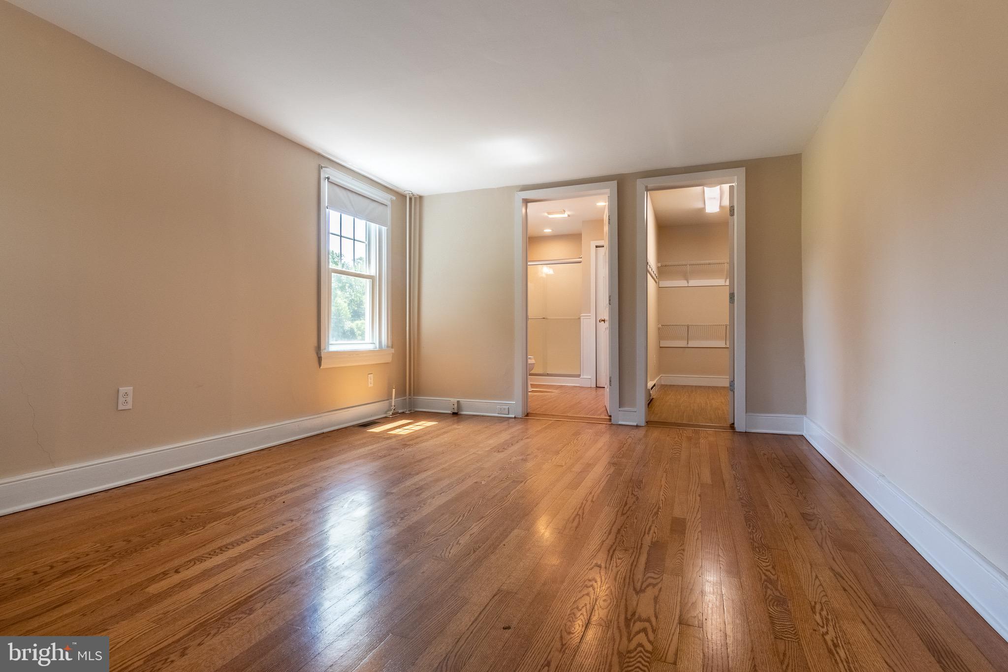 110 Lyndell Road Downingtown, PA 19335 - Photo 13 of 37 an empty room with wooden floor and windows