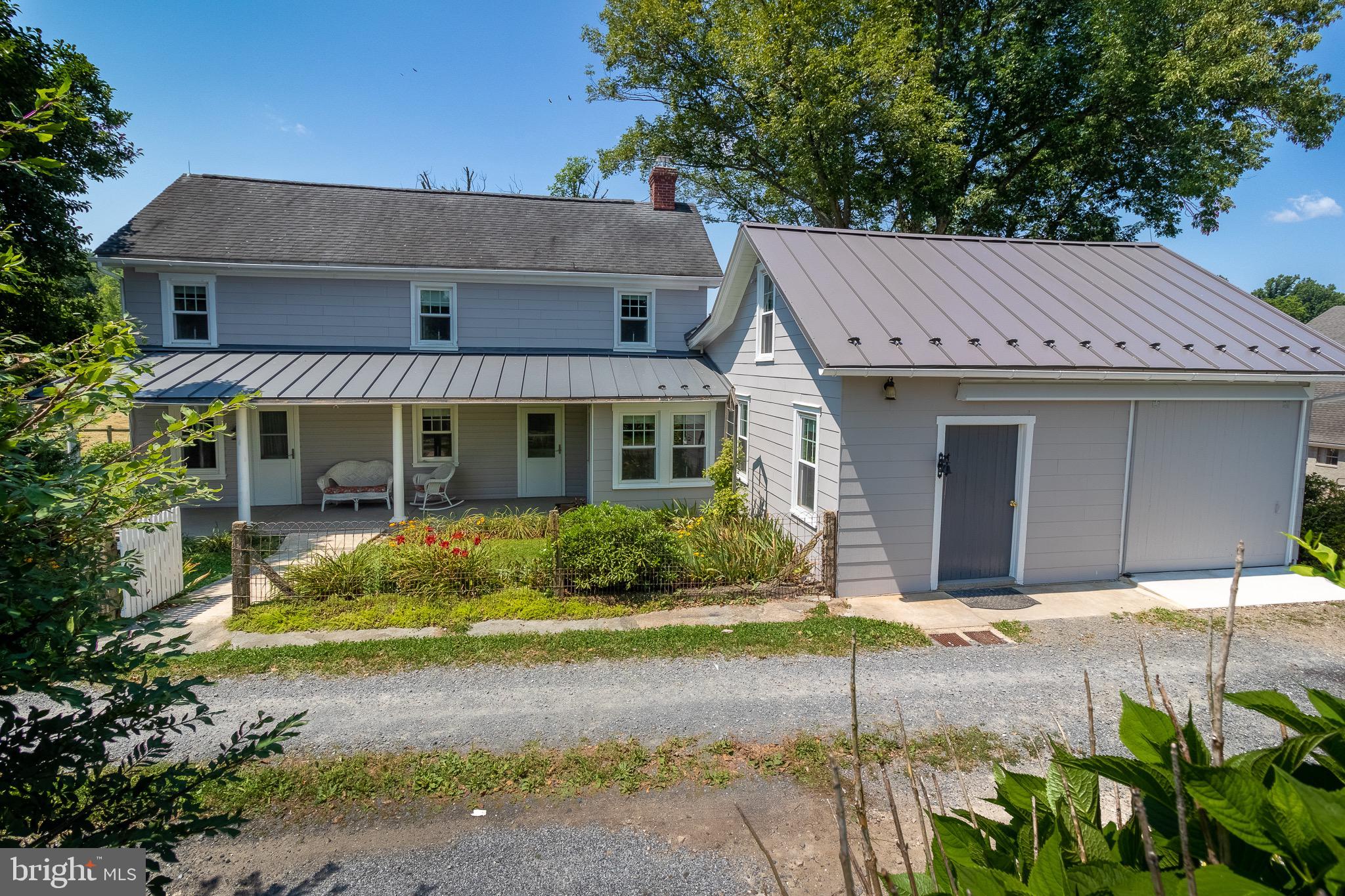 110 Lyndell Road Downingtown, PA 19335 - Photo 2 of 37 a front view of a house with a garden and plants