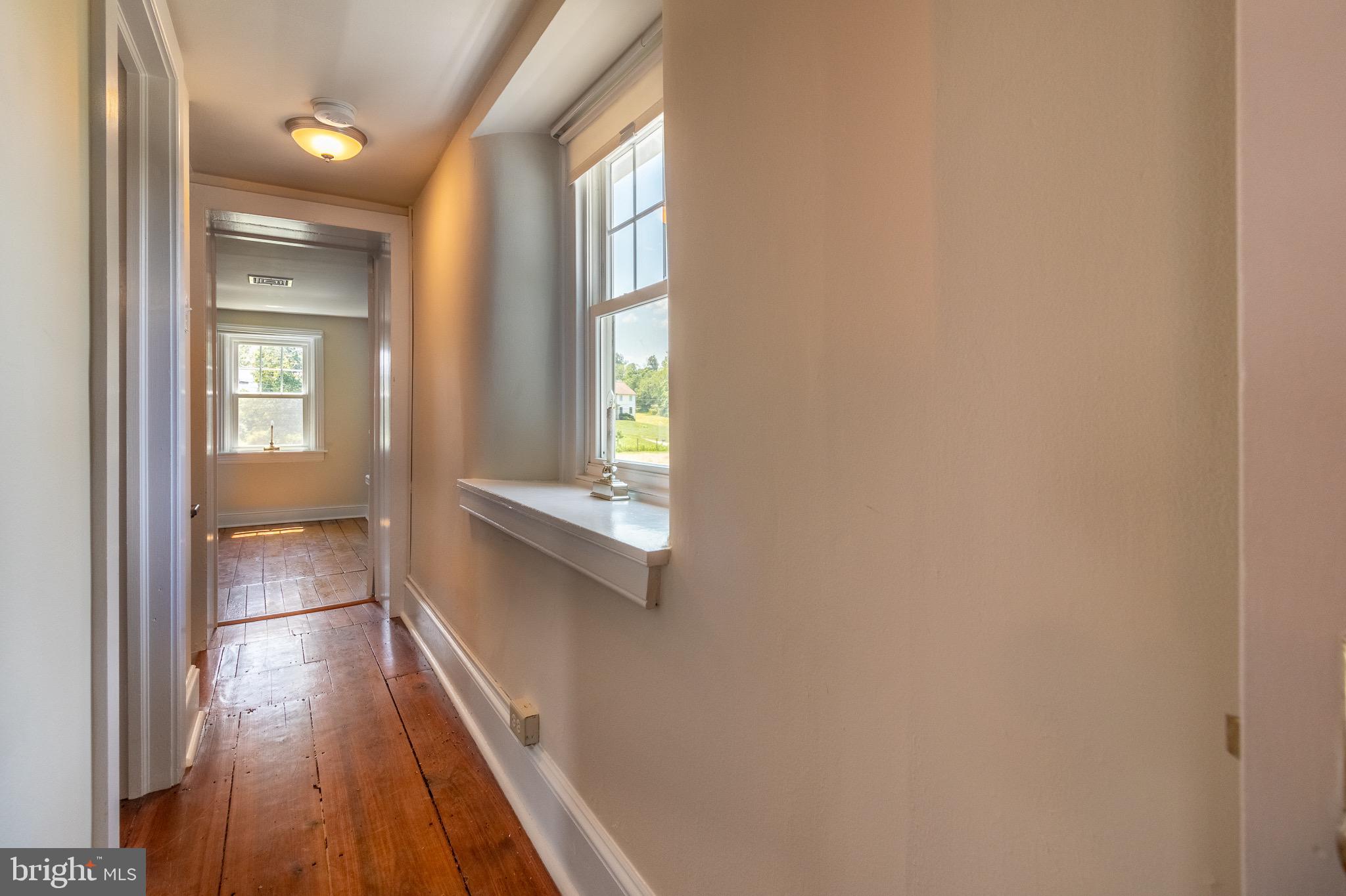 110 Lyndell Road Downingtown, PA 19335 - Photo 21 of 37 a view of a hallway with wooden floor and staircase