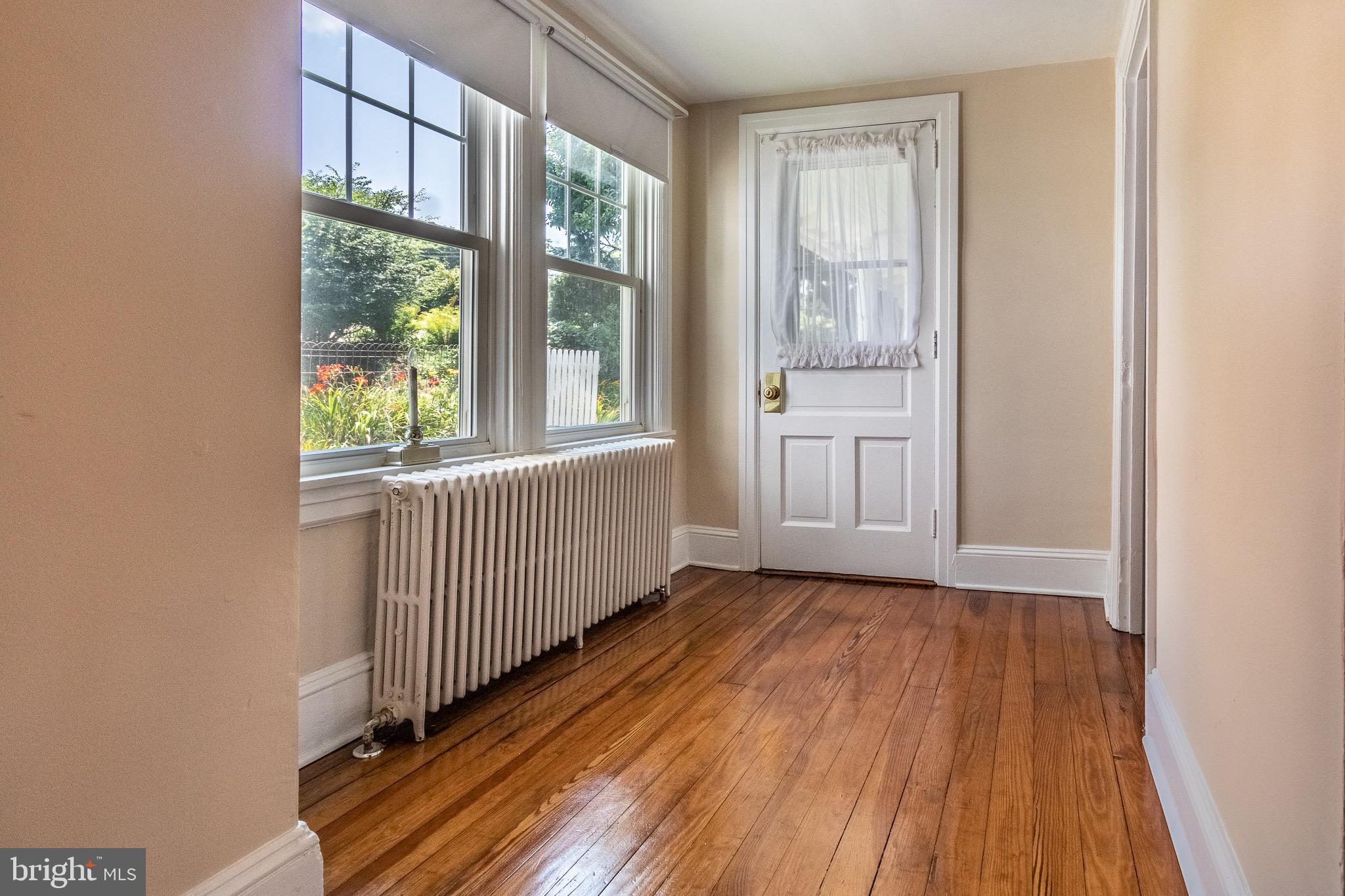 110 Lyndell Road Downingtown, PA 19335 - Photo 5 of 37 a view of an empty room with wooden floor and a window