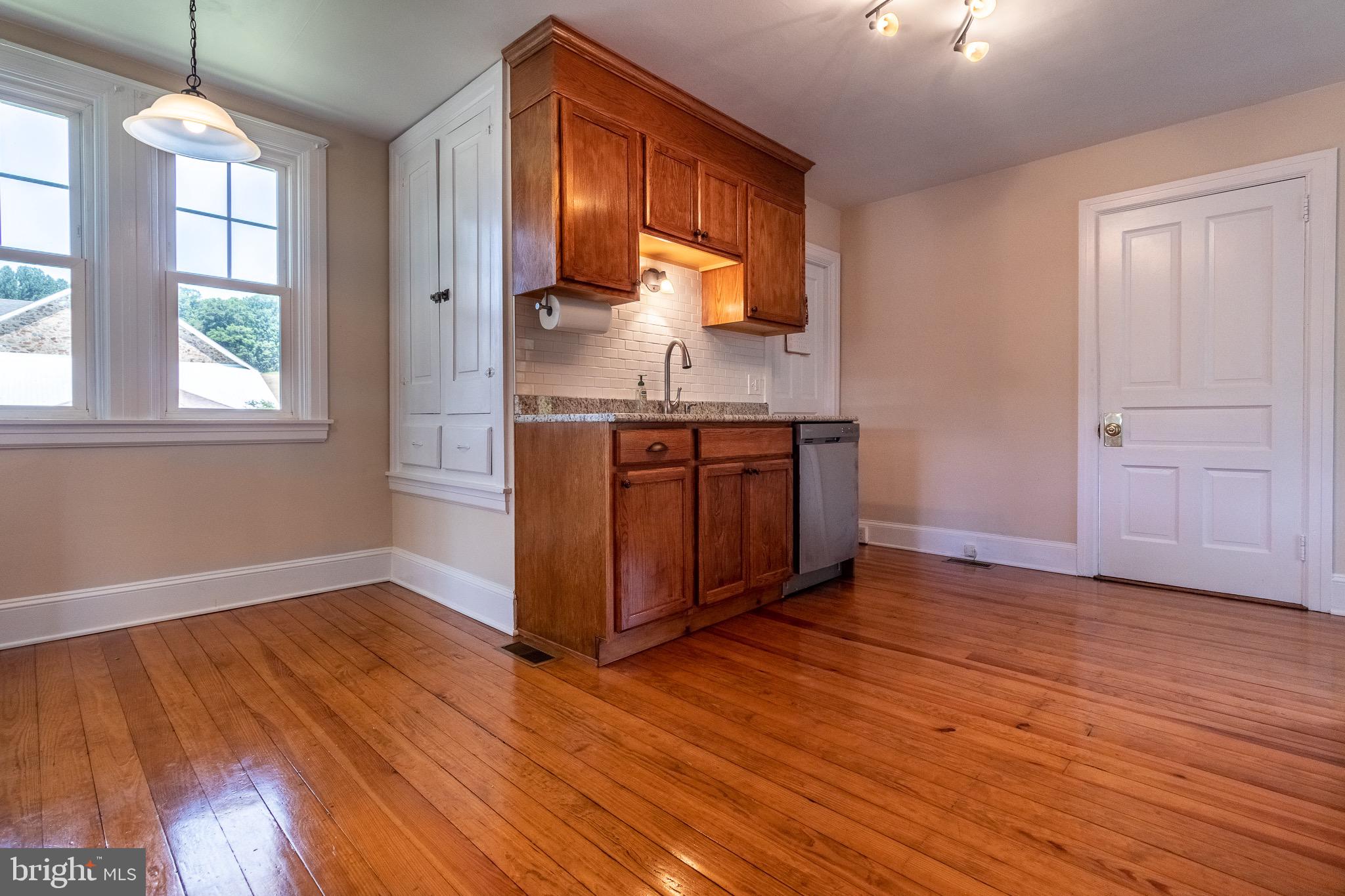 110 Lyndell Road Downingtown, PA 19335 - Photo 6 of 37 a kitchen with stainless steel appliances granite countertop a sink a stove a refrigerator cabinets and wooden floor