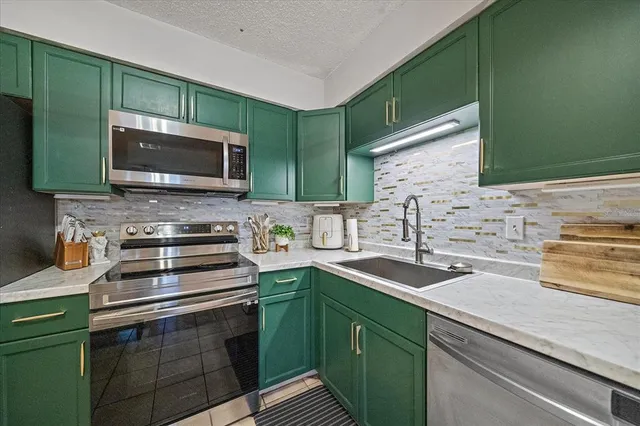 a kitchen with a sink stove and microwave