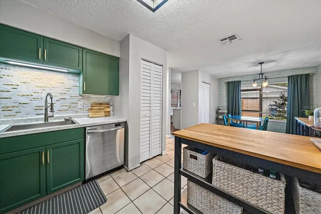 a kitchen with a sink appliances and cabinets