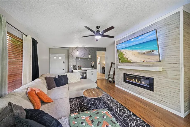 a living room with furniture a rug and a fireplace