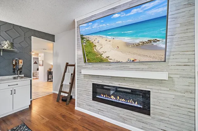 a living room with a fireplace and a floor to ceiling window